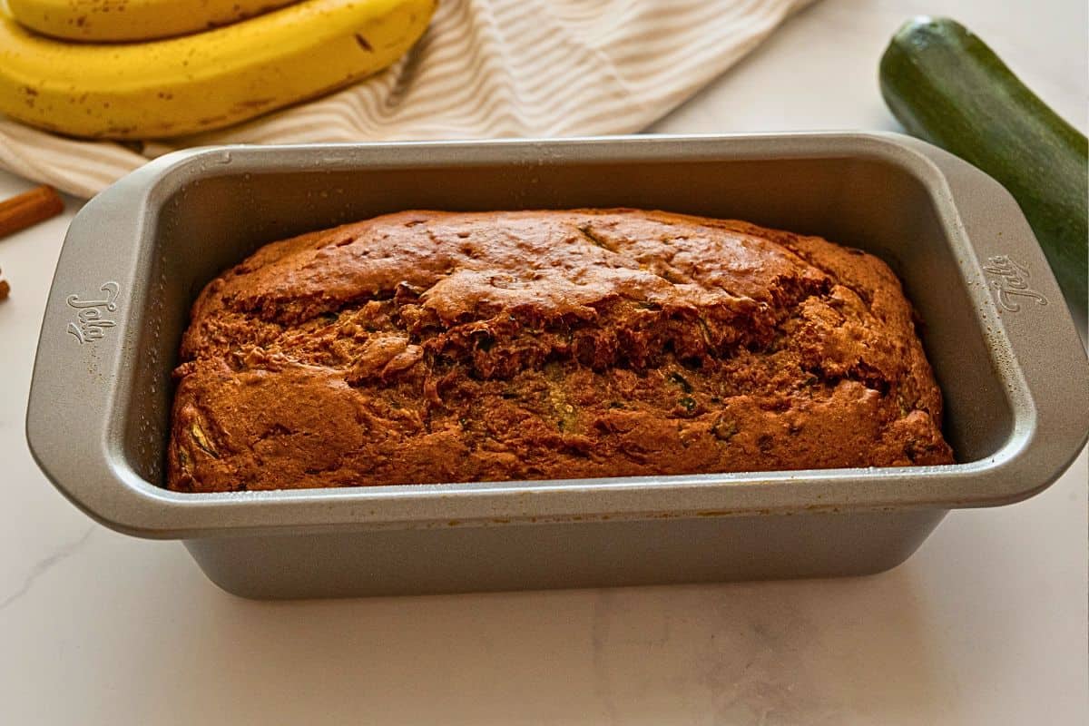 Whole Wheat Zucchini Banana Quick Bread Baked zucchini banana bread in metal loaf pan.