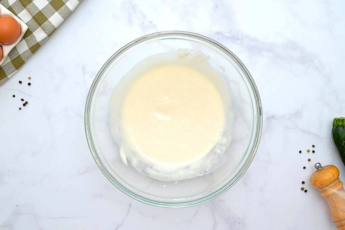 Easy Savory Zucchini Pie Recipe Flour, milk, baking powder, and salt mixed together in a large mixing bowl.