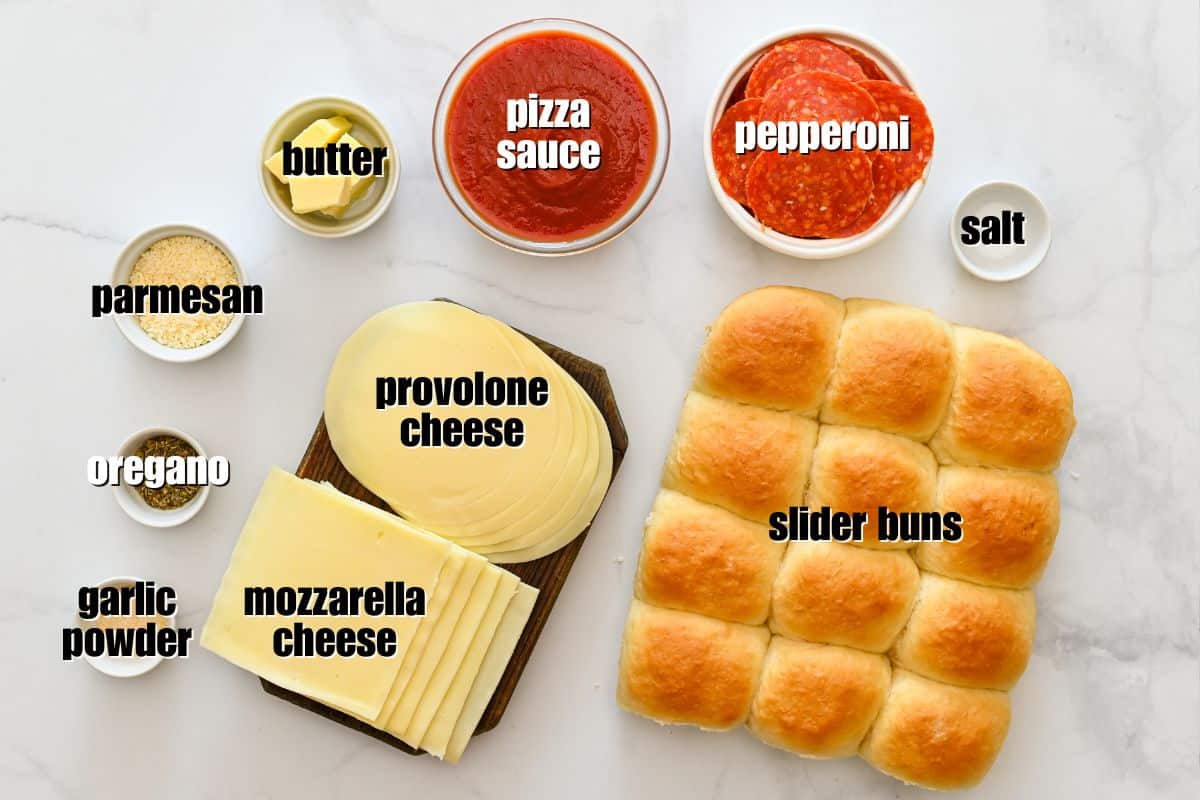 Slider buns, sliced mozzarella and provolone, grated Parmesan, pepperoni, garlic powder, butter, and Italian seasoning laid out on counter.