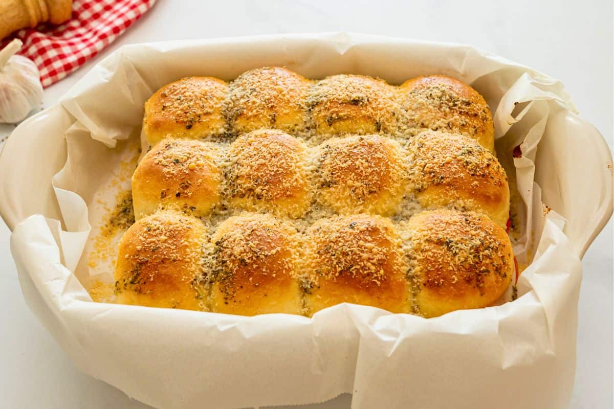 Lightly golden pizza sliders after baking in baking dish lined with parchment paper.