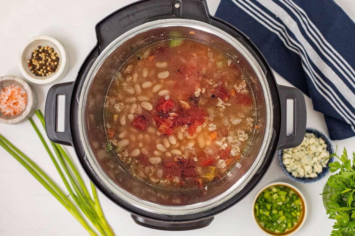 Buffalo Chicken Chili with White Beans Browned chicken, veggies, broth, white beans, hot sauce, and fire-roasted tomatoes layered inside Instant Pot.