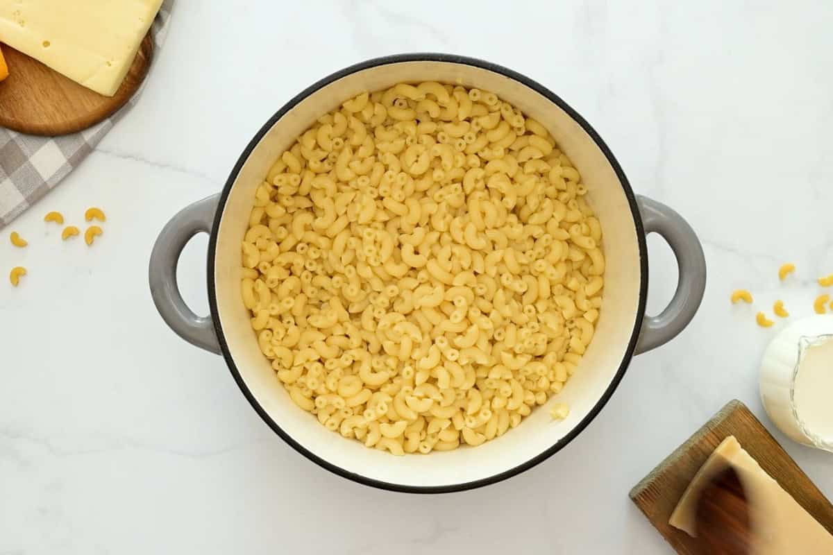 Mac and Cheese with Elbow Noodles Cooked elbow noodles tossed with a bit of butter in large saucepan.