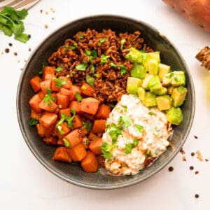 Saucy taco meat served with roasted sweet potatoes, cottage cheese, and hot honey.