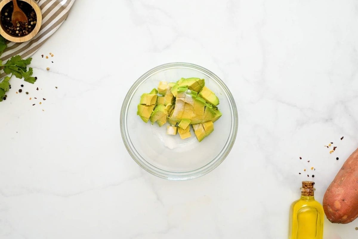 Ground Beef Sweet Potatoes and Avocado Diced avocado tossed with lime juice in small glass bowl.